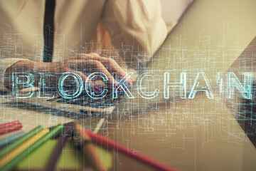 Double exposure of woman hands typing on computer and crypto market theme hologram drawing....