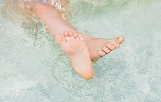 Children's feet close up in the water