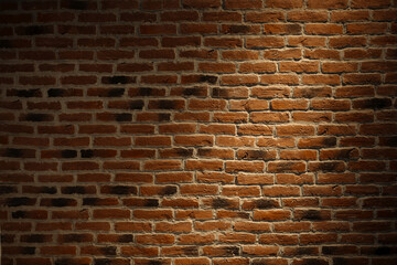 Texture of a brick wall with a light spot.
