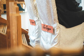 Closeup view of lettering on wedding couple chairs at wedding party. Ja-sager or Ja-sagerin means I...