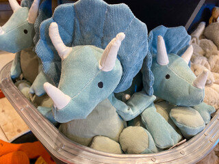 A bin of blue stuffed triceratops dinosaur toys © Joni