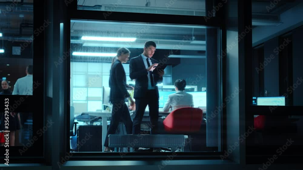 Poster Footage from Outside: Businessman Working on a Digital Tablet Computer in the Office. Manager Checking Emails while Standing by the Window. Employee Planning Financial Tasks and Business Development.