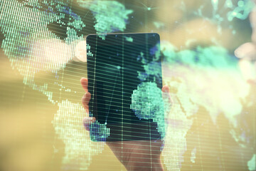 Double exposure of business theme sketch hologram and woman holding and using a mobile device.