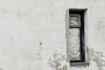 Fototapeta na wymiar Boarded building window with burnt discolored planks. 