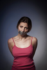 Freedom and independence concept. Psychological portrait of scared woman with  mouth covered with a plaster.