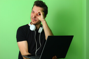 Young man or guy on a light green background. Trick emotion