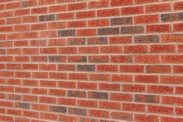 Vintage red and brown peppered look clay brick wall background