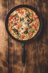 Vegetable frittata with broccoli in cast iron pan