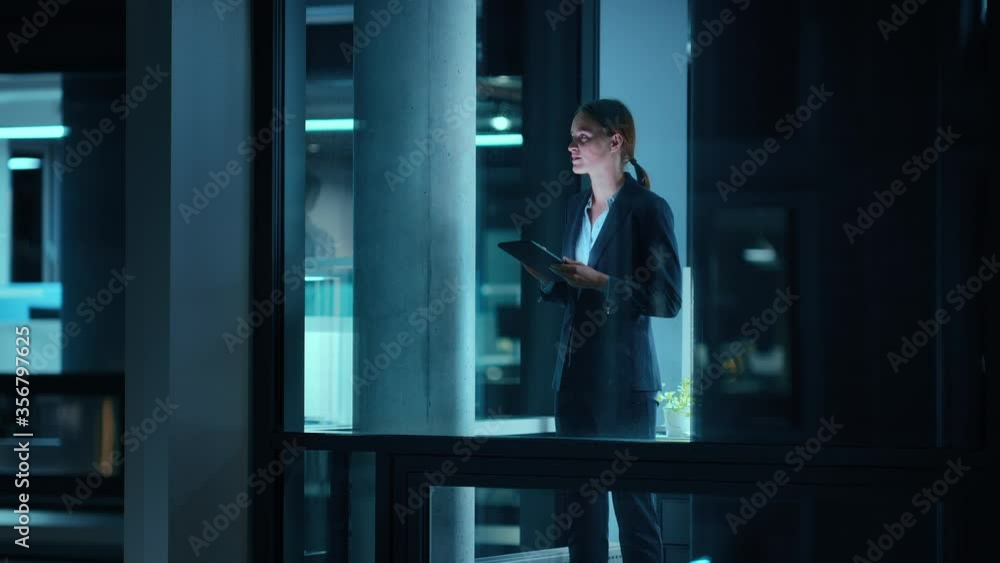 Poster Footage from Outside: Businesswoman Working on a Tablet Computer in the Office. Manager Checking Emails while Standing by the Window. Employee Planning Financial Tasks and Business Development.