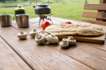 Fototapeta na wymiar fresh mushrooms and fragrant pita on the table