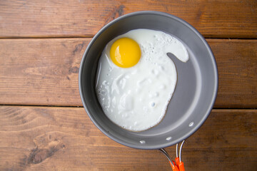 fried scrambled eggs in a pan on a picnic at the campsite