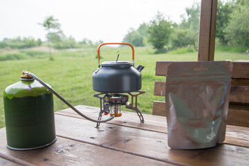a package of freeze-dried food and a gas burner for cooking on a picnic or at a campsite