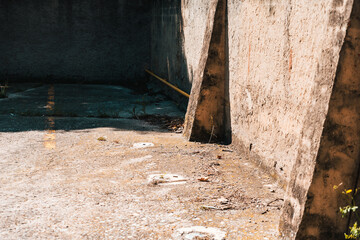 Old abandoned outdoor car park with unused concrete walls due to the economic crisis.