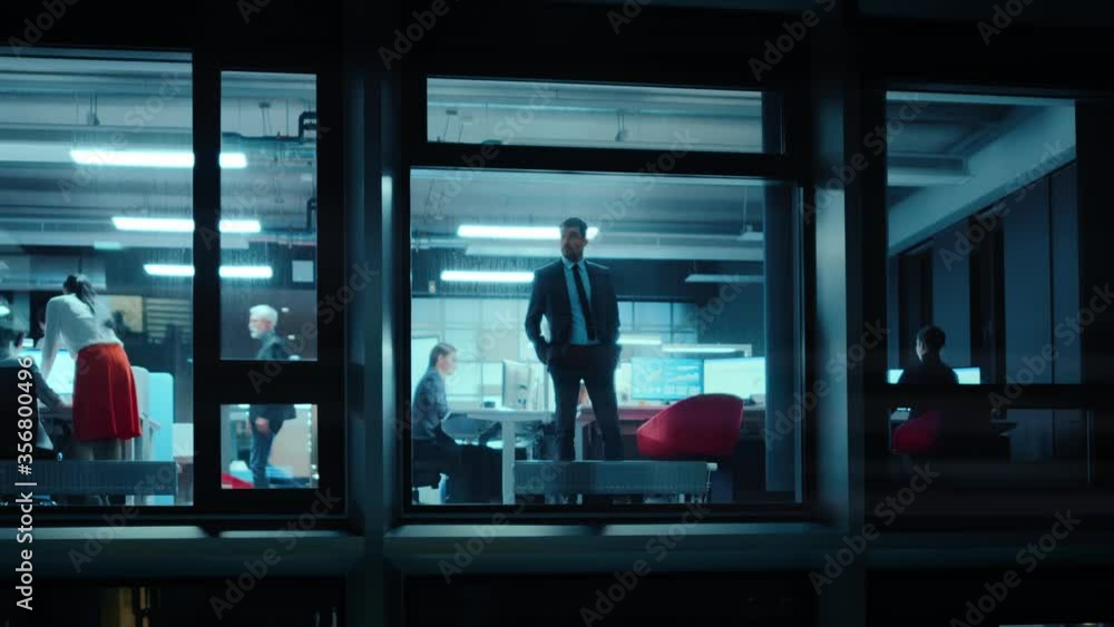 Aufkleber footage from outside the window: serious businessman walking to an office window. business managers 