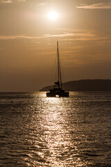 KATAMARAN WITHOUT SAIL ON A BACKGROUND OF CLOSING CLOUDS