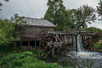 Old wooden log watermill in Russian village