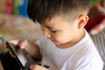Fototapeta na wymiar Happiness asian kid playing on smart phone