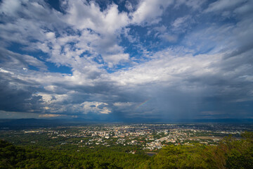 Beautiful panoramic aerial view of the city with dramatic rain and rainbow sky composite. Chiang Mai, Thailand..