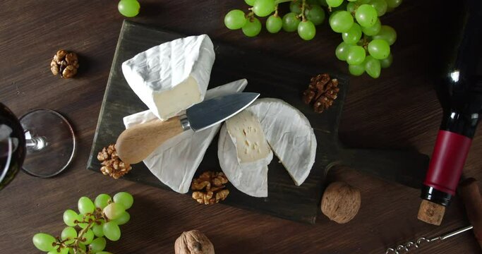 Camembert cheese on cutting Board rotates slowly.