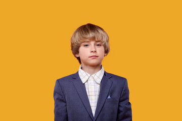 A beautiful blonde child with bright eyes looks into the camera.