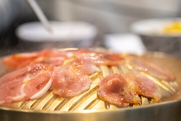 pan fries slides pork barbecue on yellow hot pan fryer 