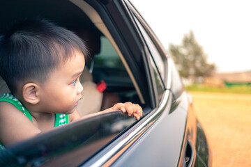 baby in car looking to outside through car window