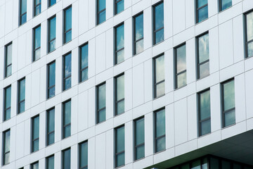 White corporate building with blue windows.