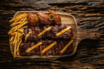 barbecue pork ribs and chicken wings with french fried and cheese