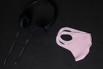 Pink Mask and Headphones on Black Background