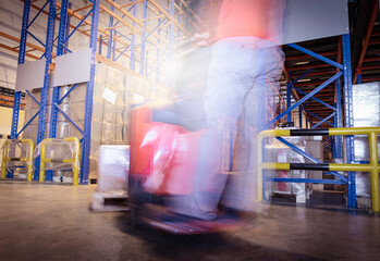motion driving of forklift unloading cargo shipment at warehouse storage.
