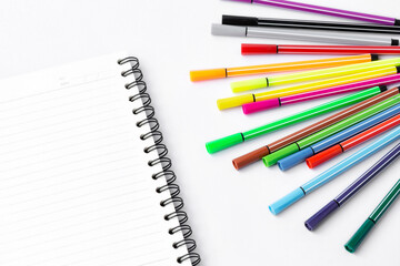 Notebook and Color pen on white background