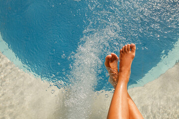 Woman's legs in jacuzzi. Female limbs soaking in a luxury spa resort jacuzzi and hydrotherapy facility with copy space