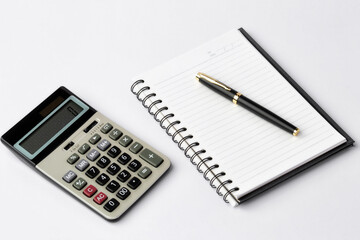 Work space on white desk with equipment office of note book, pen, calculator, Top view and copy space