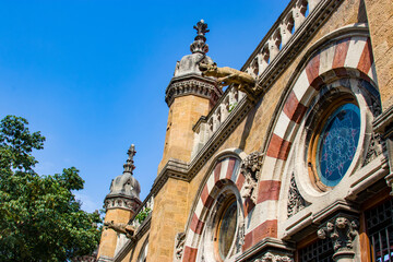 Fototapeta premium Mumbai India Nov 9th 2019: the rounded glass window and gargoyle as building’s embellishments of train station 