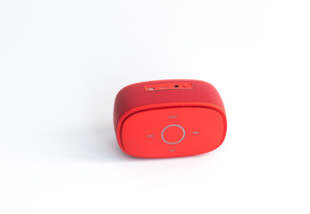 Red bluetooth speaker on white background.