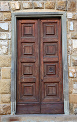Brown door in facade of residential building surrounded by bricks