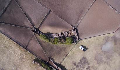 Rural scenic. Sheepfold. Overhead aerial view of a herd of sheep gathered in the pen in the farm. 
