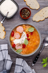 Soup with rice and beans, sausages and vegetables