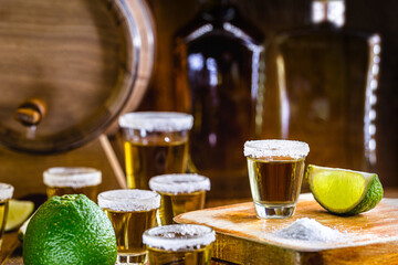 Distilled drink with salt and lemon. Glass of tequila, typical mexican drink in a bar. International Tequila Day.