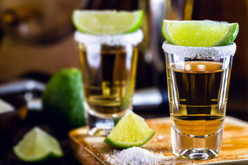 glass of tequila, a drink of Mexican culture, made of distilled alcohol, lemon, salt and blue agave. International tequila day.