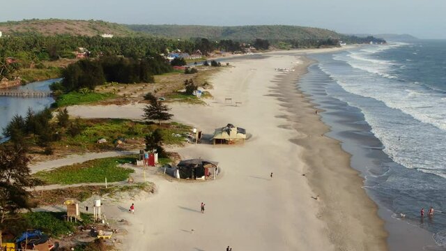 people walking along the beach india, goa, arambol - mandrem