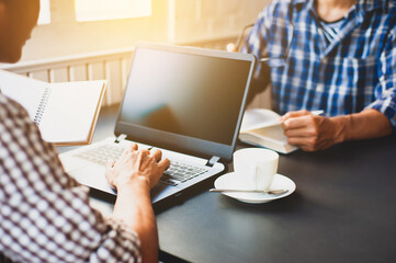 Two students are studying to find information about doing academic projects.