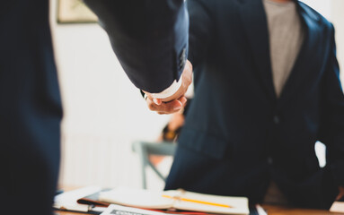 Handshake with business partners in the meeting.