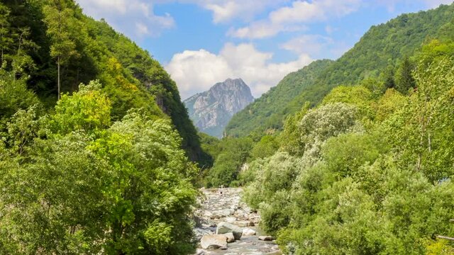 Timelapse of Mongioie peak in Nava and the river Tanaro leading to the mountain in Ormea valley.  Summer travel holiday vacation vibes. Spot for trekking and camping. In Liguria and Piemonte, Italy.