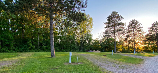 RV campsite with hook-up at sunset in the woods