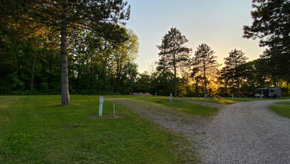 RV campsite with hook-up at sunset in the woods