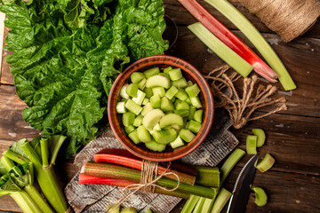 fresh ripe healthy rhubarb stalks on wooden board. Food recipe background. Close up. top view