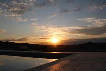 sunset near swimming pool