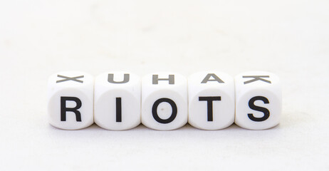 The term riots displayed visually on a clear background in black text image with copy space in horizontal format