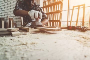 Carpenter working on wood craft at workshop to produce construction material or wooden furniture....